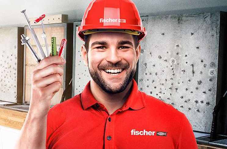 Fröhlicher fischer Mitarbeiter hält verschiedene Dübel nach oben